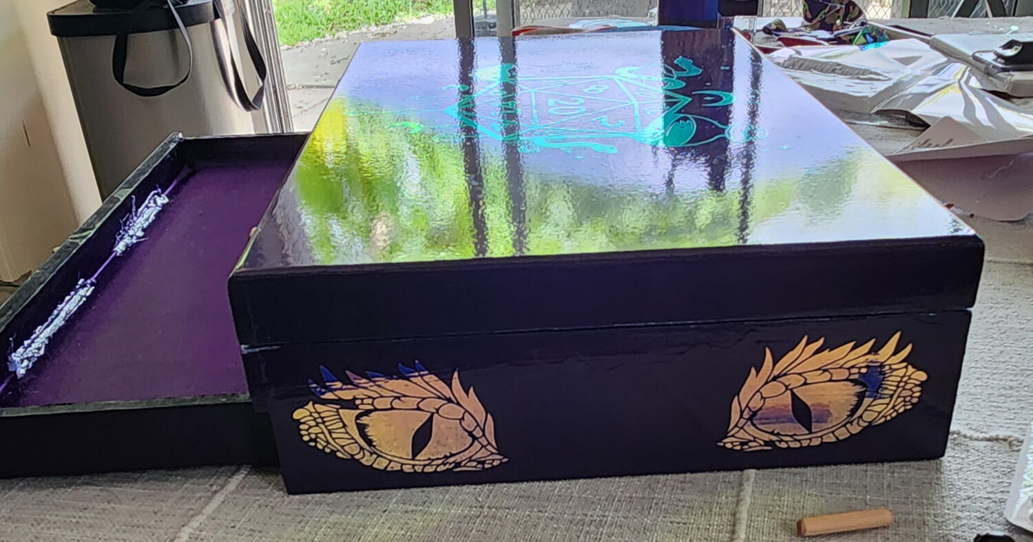High-gloss black dice box with gilded dragon eyes painted on the sides